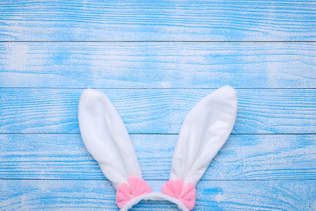 White rabbit bunny ears on blue wooden background. Symbol Happy Easter Flat lay Copy spaceの写真素材