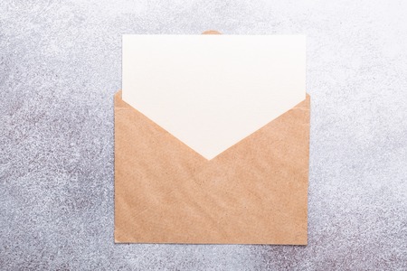 Blank paper with envelope on grey background Top view Copy spaceの写真素材