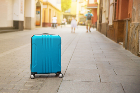 Blue suitcase on European city street, tourism in Europe, travel background Copy spaceの写真素材