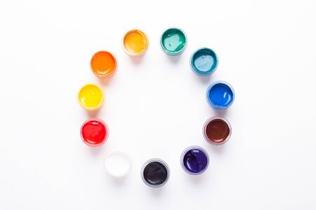 Multicolored gouache on a white background Circle shape Isolated Paints in containers Top view Copy spaceの写真素材