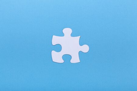 Closeup of jigsaw puzzle on blue background Missing jigsaw puzzle piece, business concept for completing the piece Teamwork conceptの写真素材
