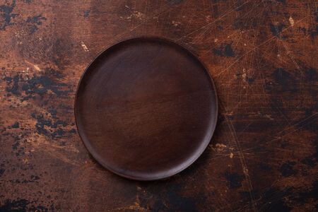 Empty plate and linen napkin on brown wooden background Copy space Top view - Imageの写真素材