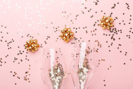 Christmas flat lay. Champagne glasses and gold decoration on pink background - Imageの写真素材
