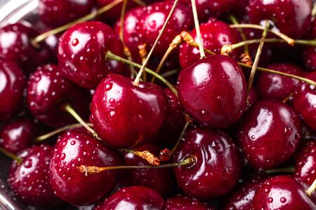 Close up of fresh cherry berries. Drops of water on the surface of berries. Selective focus. Macro background - Imageの写真素材