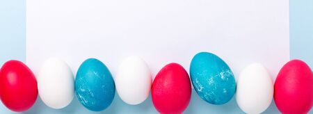 Spring mockup with Easter eggs and blank of white paper on blue background. Easter concept. Copy space. Top view - Imageの写真素材