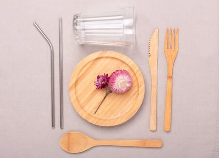Zero waste, plastic free concept. Wooden plate, glass cup, Set of bamboo cutlery. Flat lay on textile linen background - Imageの写真素材