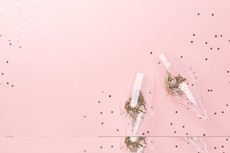 Christmas flat lay. Champagne glasses and gold decoration on pink background - Imageの写真素材