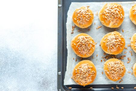 Fresh homemade burger buns on baking sheet. Top view - Imageの写真素材