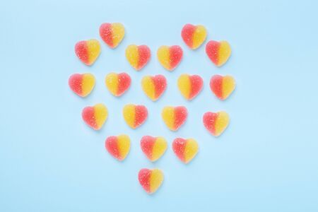 Colorful gummy hearts on blue background. Jelly sweets in shape of heart. Top view - Imageの写真素材