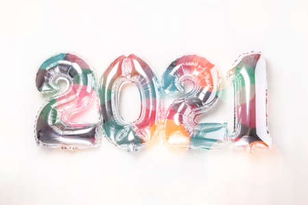 Silver balloons in the form of numbers 2021 on white background. New year celebration. Happy New...