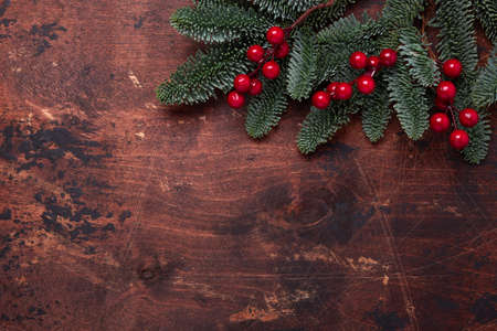 Christmas background with fir tree branches and holly. Top view. Copy space - Image