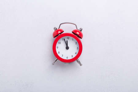 Red alarm clock on stone background. New Year or Christmas concept. Top view. Copy space - Image