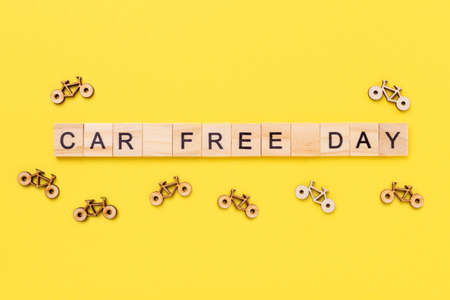 Text Car Free Day and small bicycles on yellow background. Concept of world car free day on September 22. Top view - Imageの写真素材