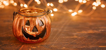 Halloween pumpkin head jack glass lantern. Halloween decoration on wooden table background, selective focus - Imageの写真素材