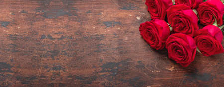 Red rose flowers bouquet on wooden background Valentine's day horizontal banner. Copy space. Top view - Imageの写真素材