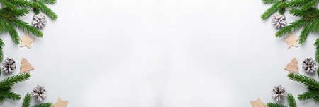 Christmas horizontal banner. Fir tree branches with red christmas balls on white background. Top...