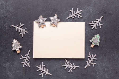 Christmas greeting card template. Empty paper mock up with silver decor on dark stone background....