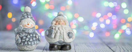 Christmas greeting card with decorative cute snowman and Santa Claus. Bokeh effect on background. Horizontal banner - Imageの写真素材