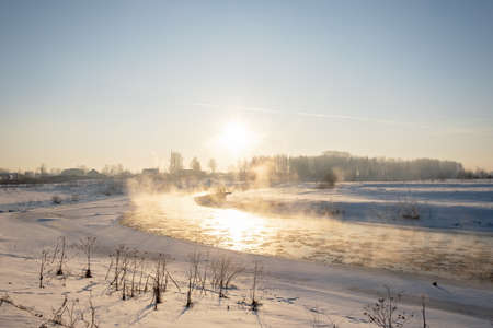 Winter snow river landscape. Rural scene. Ice floats on the river. Steam escaping over the frozen river in winter - Imageの写真素材
