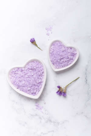Lilac spa sea salt on marble background. Daily bodycare concept, natural bath products - Image