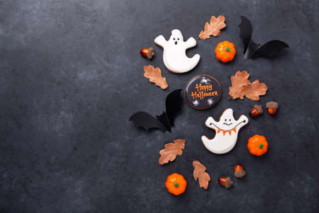 Halloween greeting card with copy space. Set of Halloween gingerbread cookies on dark stone backgroundの写真素材