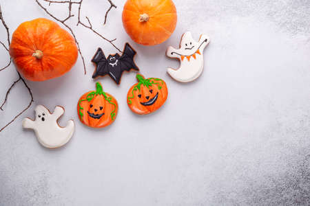 Fresh gingerbread cookies, Halloween decorations, paper bat on stone background. Halloween conceptの写真素材