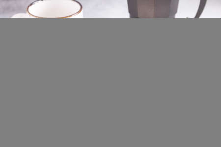 Cottage cheese pancakes with fresh berries, cup of coffee and coffee maker on the table. Tasty breakfast foodの写真素材