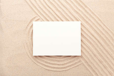 Blank card mockup on sand background. Lines drawn on the sand. Top view. Minimal designの写真素材