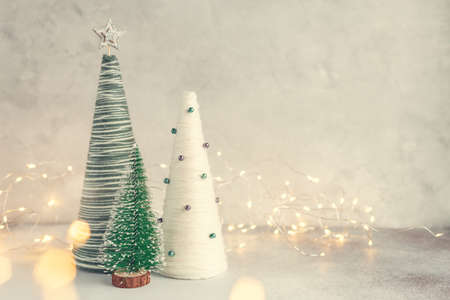 Handmade Christmas trees. Yarn wrapped cone trees and garland. Craft decorations to decorate your home during the holidaysの写真素材