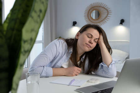Tired woman sleeps on her working place. Professional burnout, fatigue and sleep disorder concept