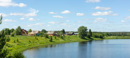 Typical Russian landscape. Russian village on the shore of the lake. Panoramic photoの写真素材