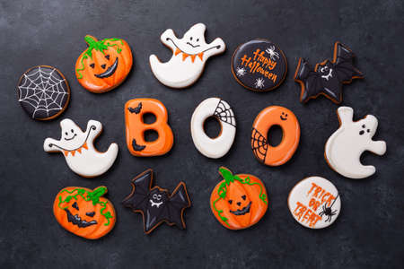 Halloween gingerbread cookies on dark stone background. Bright homemade cookies for Halloween party - Imageの写真素材