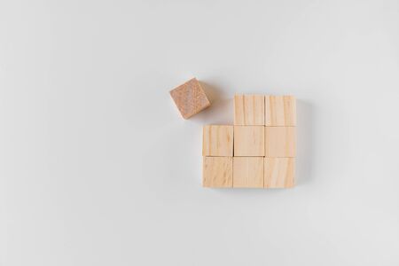 Group of wooden on a white background, laid out in a square and one of them is knocked out of the general drawing
の写真素材
