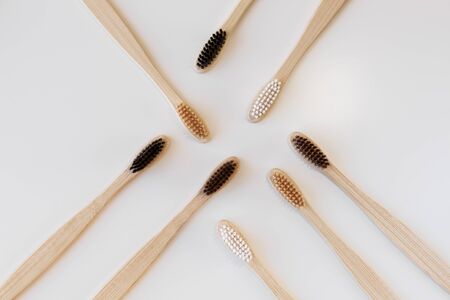 Group of eco bamboo toothbrushes, on white background. Different color. Top view, copy space....
