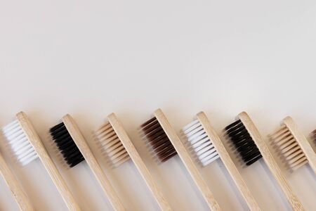 Group of eco bamboo toothbrushes, on white background. Different color. Top view, copy space. Natural organic product for oral hygiene. Dental zero waste and no plastic concept. Safe for the earth. の写真素材