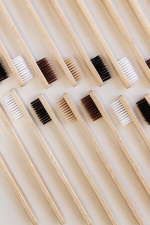 Group of eco bamboo toothbrushes, on white background. Different color. Top view, pattern,...