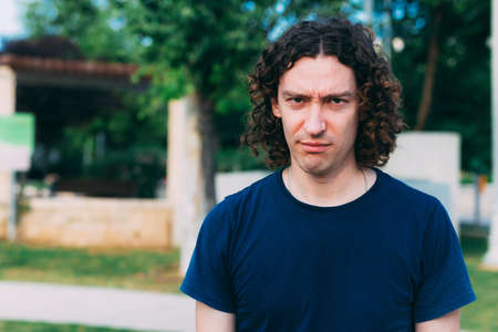 Father's day. Dad was upset that no one congratulated him on the holiday, in a blue T-shirt and frowns, looking at the cameraの写真素材