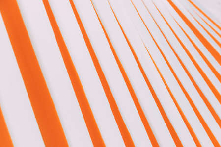 Abstract orange and white lines building. Orange pattern on white background. Geometric pattern. Wall. Construction in the city park from a certain point. Lovely orange lines. Background, wallpaperの写真素材