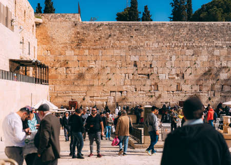 Jerusalem western wall with people. Cityscape image of Jerusalem. View of prayers, wishes and prays. Dome of the Rock in Jerusalem old city, Israel. Blue sky. Jerusalem day celebrationのeditorial素材