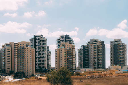 New buildings. Many new houses in the east of Israel. Residential buildings against a blue sky with...
