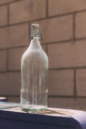 Glass bottle on the bottle trash can. Reducing waste by following the green concept. Recycling...