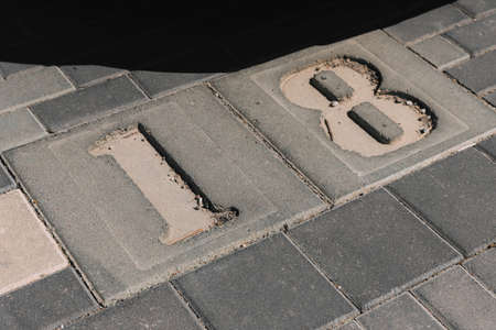 Parking place with 18 number. Close-up of a number marking in a parking lot. Empty parking lot,...