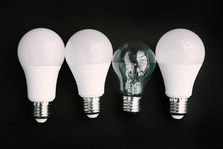Incandescent lamp and LED lamps on a black background. Eco concept of saving electricityの写真素材