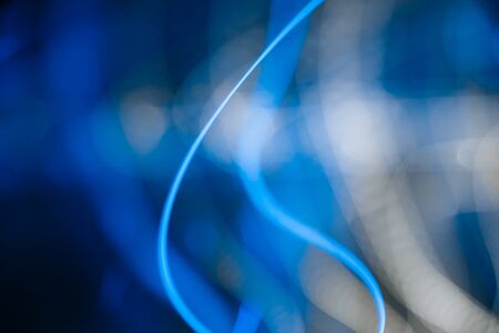 Colorful pattern of blue dynamic neon lines. Modern background. Art concept of lighting effects.の写真素材