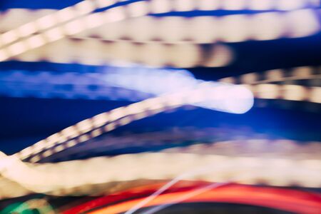 Colorful pattern of red, blue and orange dynamic lines of light. Modern blurred background. Art...