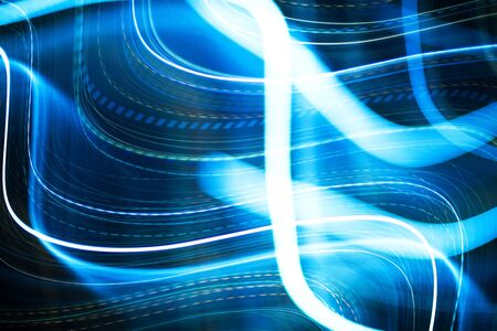 Colorful pattern of blue dynamic neon lines. Modern background. Art concept of lighting effects.の写真素材