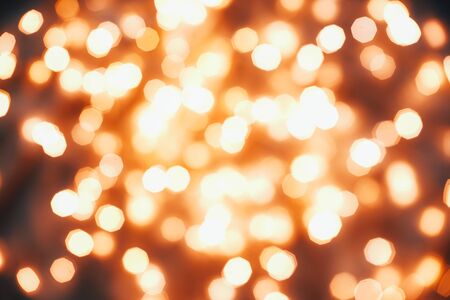 Bright blurry christmas lights against a dark background. Background for your design.