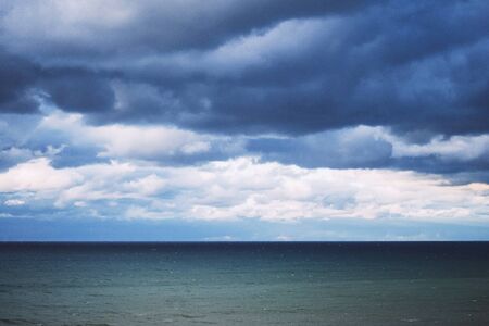 Dark clouds and waves at sea. Storm in the winter.の写真素材