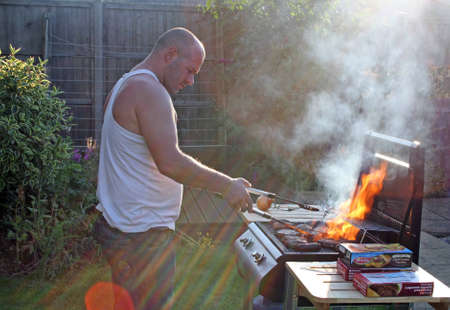 man cooking at the bbqの写真素材