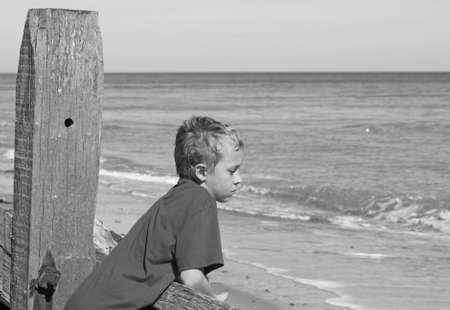 teenage boy looking out to seaの写真素材